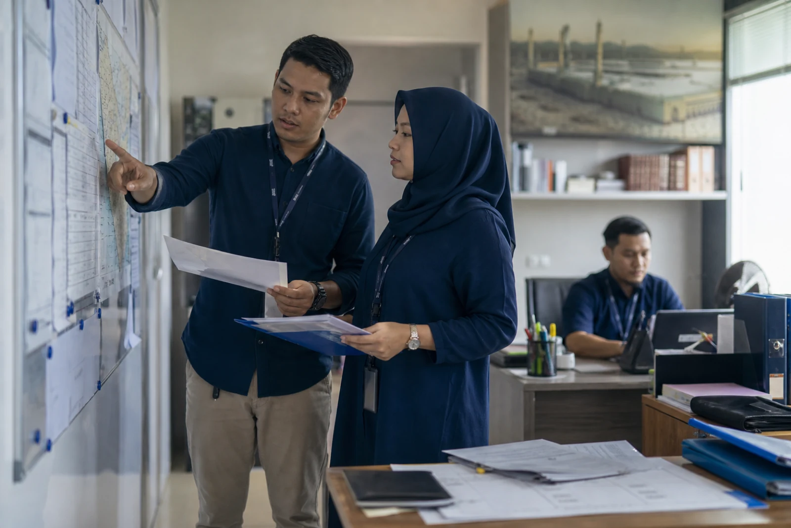 Umrah travel specialists coordinating traveler readiness in an operations office